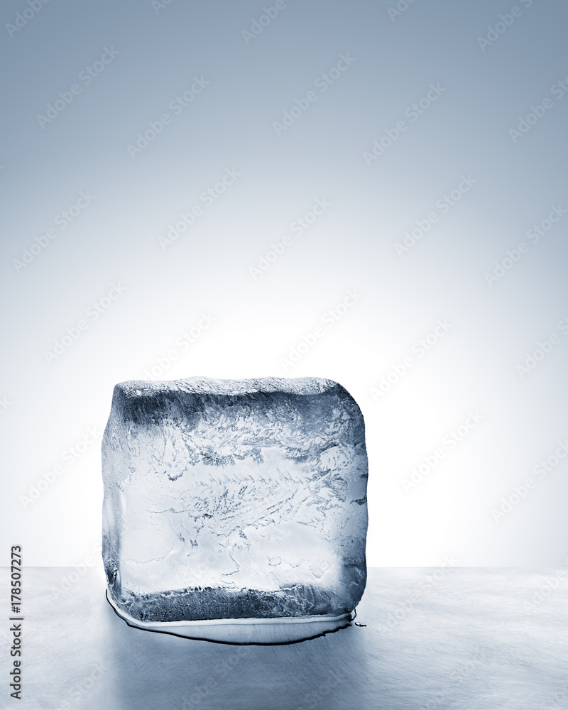 Summer heat relief, frosty cold blue ice block melting on scratched steel surface Summer heat relief, frosty cold blue ice block melting on scratched steel surface