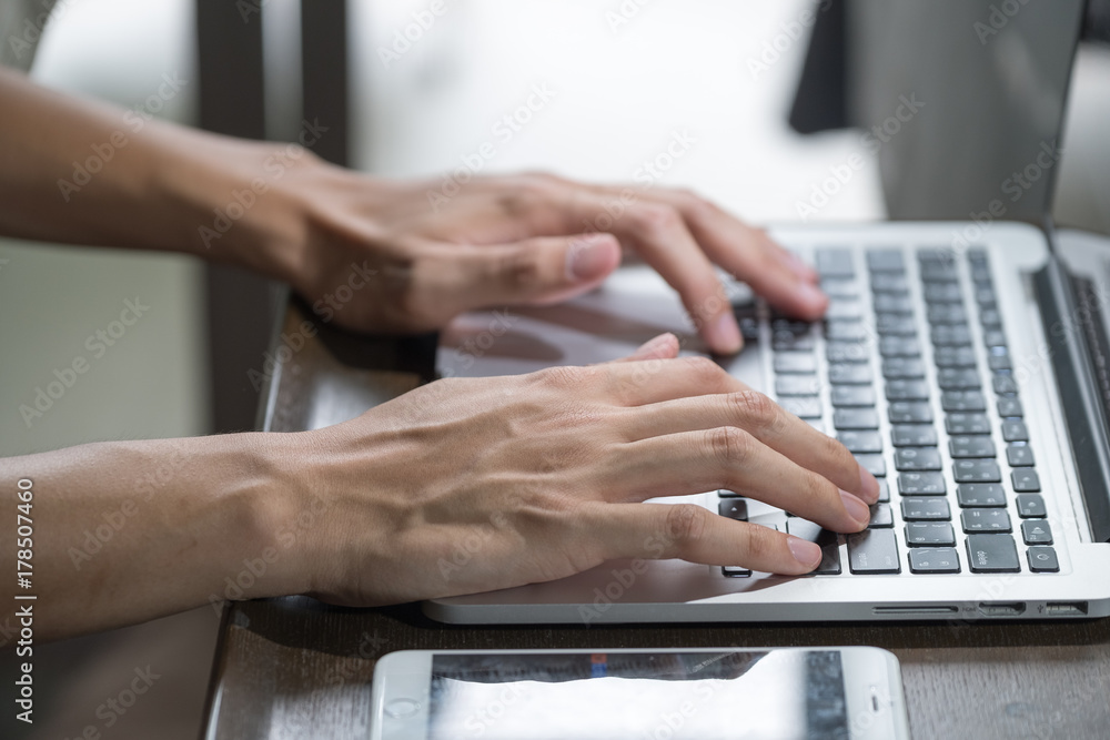 Businessman hand using laptop and tablet with social network Businessman hand using laptop and tablet with social network