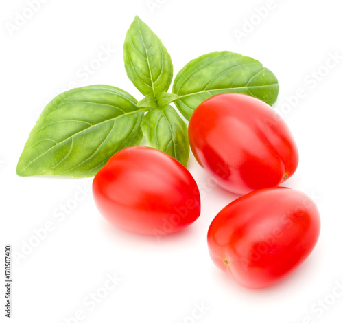 fresh plum tomato with basil leaf isolated on white background