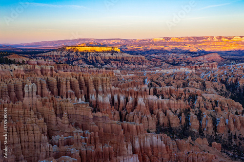 The magnificent crimson colored hoodoos of Bryce Canyon National Park at sunset in the early winter.