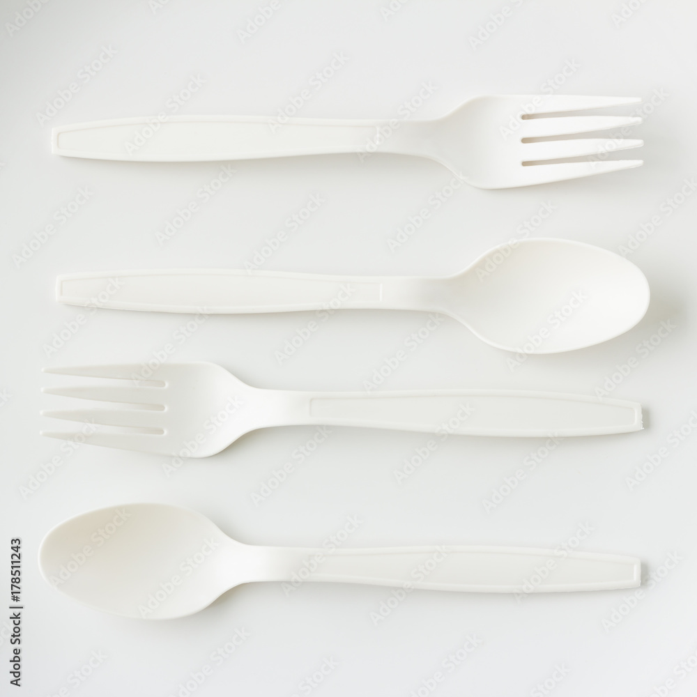 spoon and fork on grey background in top view spoon and fork on grey background in top view