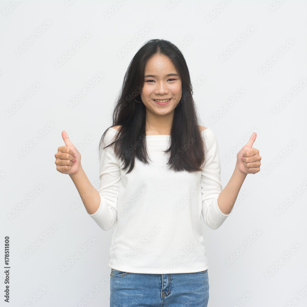Happy young woman giving thumbs up isolated on white background Happy young woman giving thumbs up isolated on white background