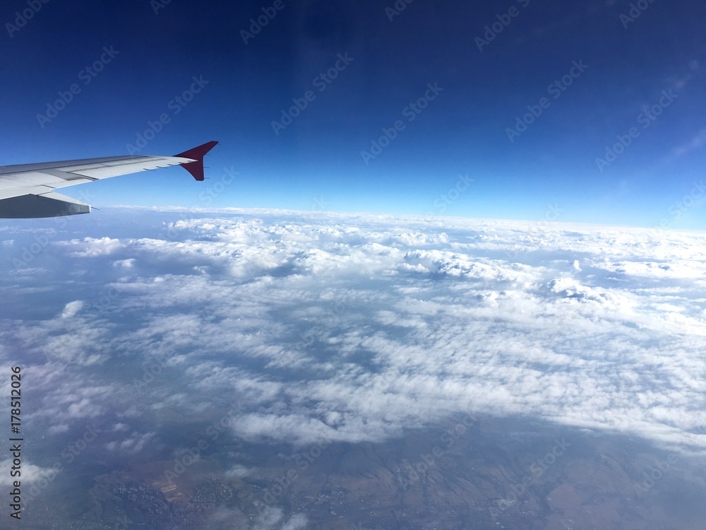 Fototapeta premium Above the white clouds. View from the plane