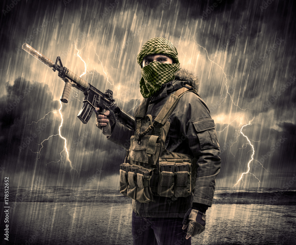 Dangerous armed terrorist with mask and gun in a thunderstorm with lightning Dangerous armed terrorist with mask and gun in a thunderstorm with lightning