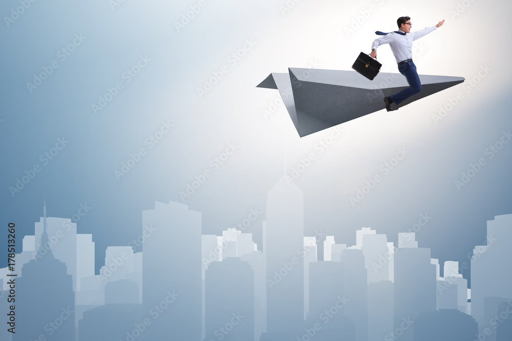 Businessman flying on paper plane in business concept Businessman flying on paper plane in business concept
