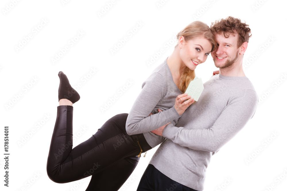 Cheerful couple together with building model Cheerful couple together with building model