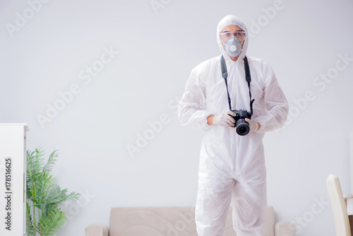 Forensic expert at crime scene doing investigation photo