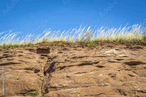 Orange rock close-up against a blue sky. photo