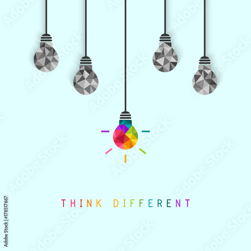 Think different concept with creative and colorful lightbulb being more unique than the surrounding grey ones photo