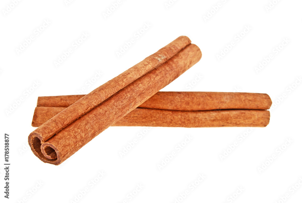 Two cinnamon sticks isolated on a white background. Close up. Two cinnamon sticks isolated on a white background. Close up.