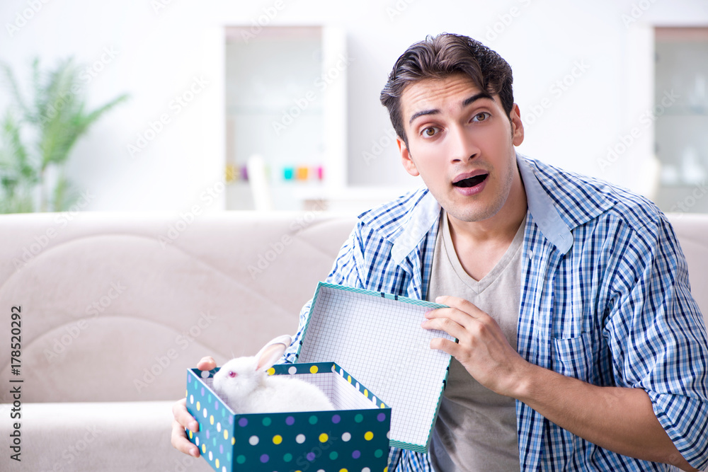 Young man getting rabbit as birthday present Young man getting rabbit as birthday present