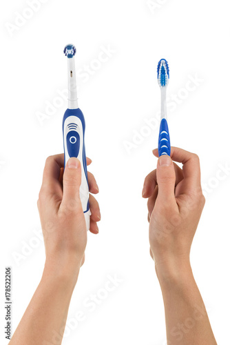 Female hands  take electric and manual toothbrushe isolated on white background