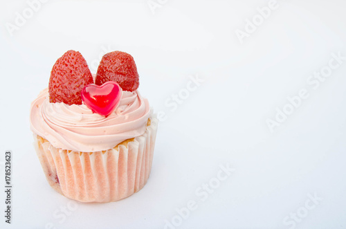 Delicious strawberry cupcakes with heart-shaped jelly are perfect for Valentine's Day backgrounds.