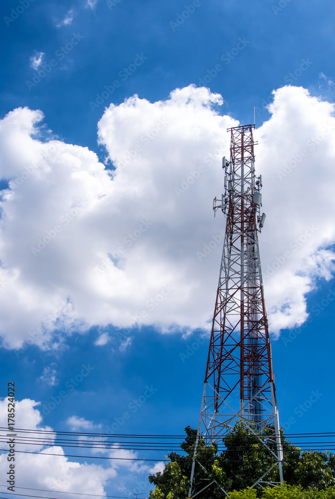 Telecommunication equipment on the steel structure tower and the white clouds in blue sky
