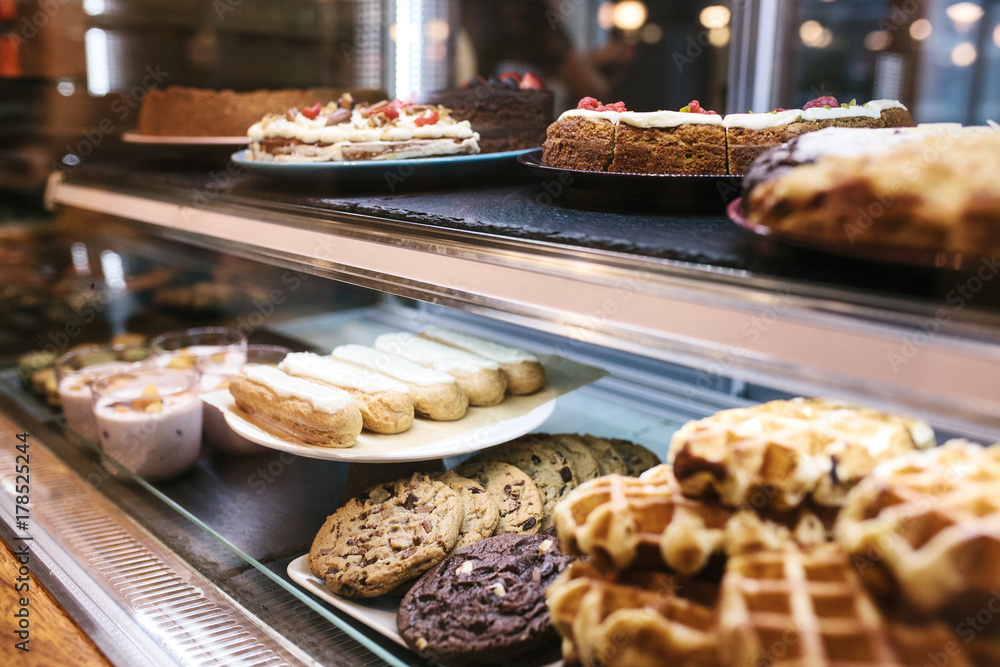 Large selection of cakes and pastries on the counter in a cafe. Sale of delicious sweets. Large selection of cakes and pastries on the counter in a cafe. Sale of delicious sweets.