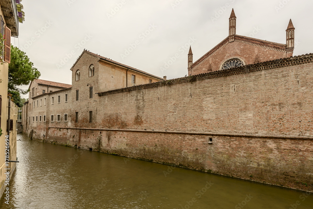 outer wall of San Francesco monastery on Rio canal in city center, Mantua, Italy