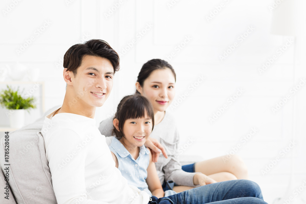 Happy asian family on sofa in living room Happy asian family on sofa in living room