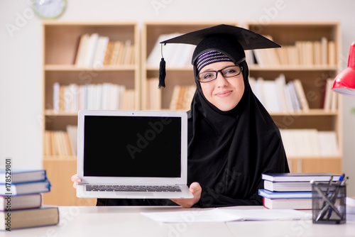 Muslim girl in hijab studying preparing for exams