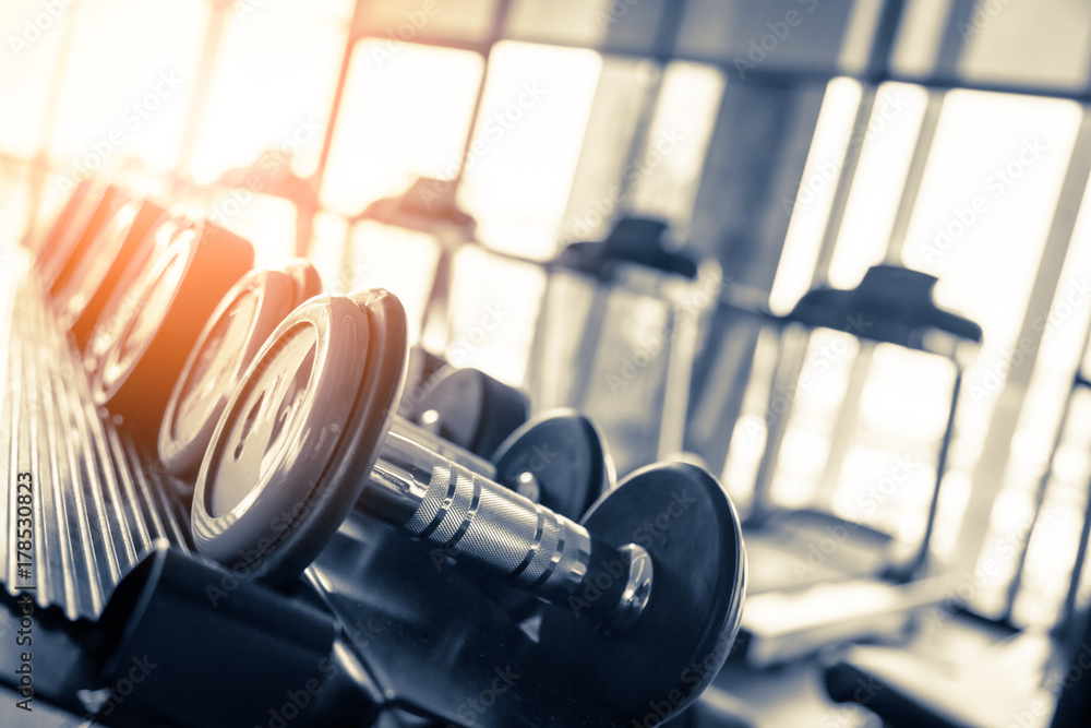 Fototapeta premium Rows of dumbbells in the gym with hign contrast and monochrome color tone
