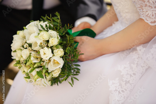 Bride holding bouquet of fresh flowers. Wedding concept