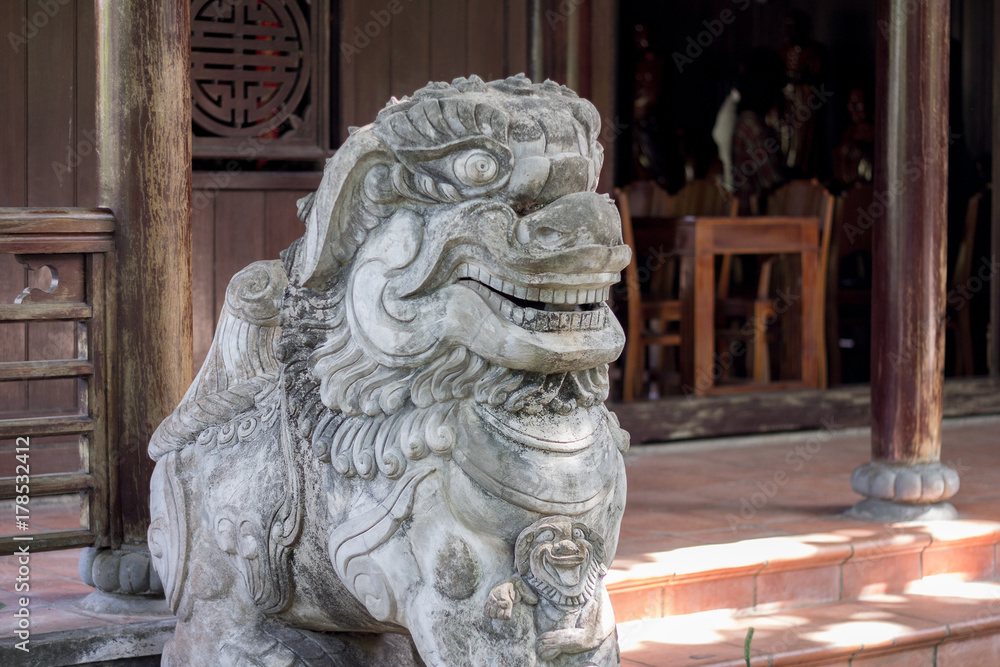 stone statue of lion guarding chinese temple stone statue of lion guarding chinese temple
