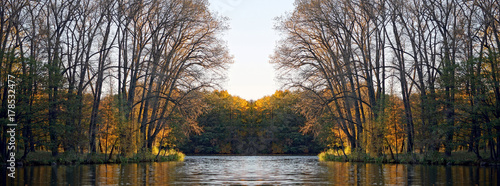 park in the fall in the sun. Reflection in water and mirror symmetry © Anatoliy