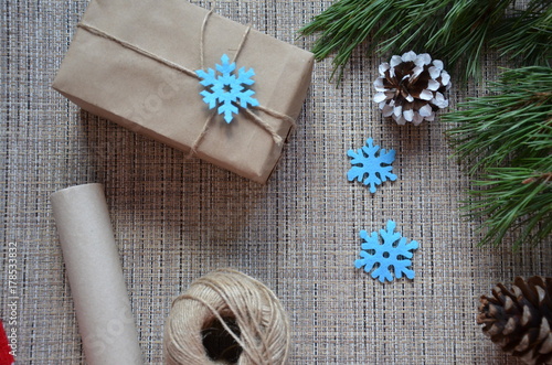 Christmas composition. Christmas gift, knitted blanket, pine cones, fir branches on wooden white background. Flat lay, top view snowflakes christmas treats christmas decorations photo