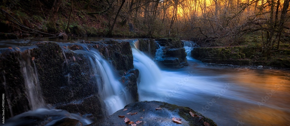 Fototapeta premium Evening at the Afon Pyrddin river near Pontneddfechan, on the south side of Brecon Beacons National Park, South Wales, UK, known as Waterfall Country