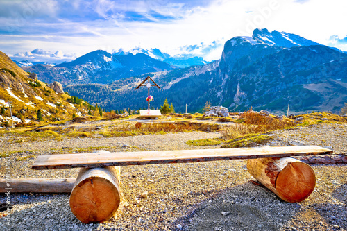 Bench and cross in Valparola Pass alpine destination photo