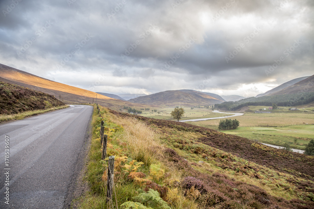 road through beautiful landscape of cairngorms national park in scotland