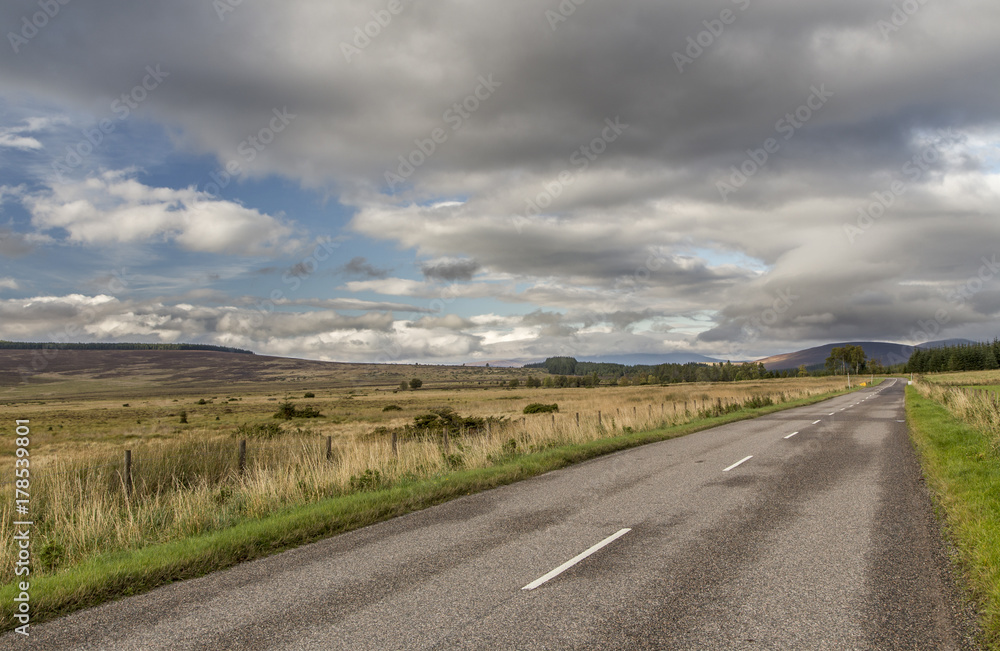 road through beautiful landscape of cairngorms national park in scotland