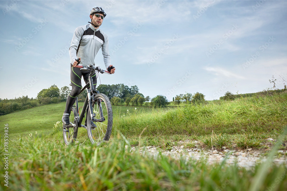 Mountainbiker in grüner Landschaft Mountainbiker in grüner Landschaft