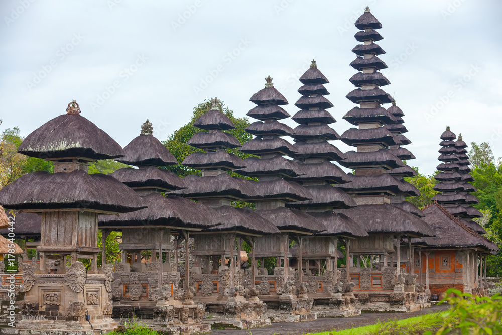 The temple complex, built of stone and wood, with roofs Meru from coconut fiber. Taman Ayun Temple of Mengwi Empire, Badung regency, Bali, Indonesia. The temple complex, built of stone and wood, with roofs Meru from coconut fiber. Taman Ayun Temple of Mengwi Empire, Badung regency, Bali, Indonesia.