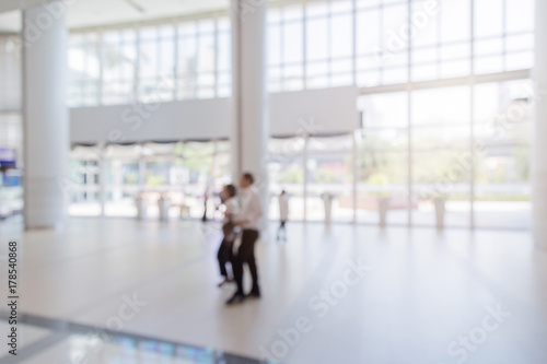 blur image background of hall in shopping mall with people