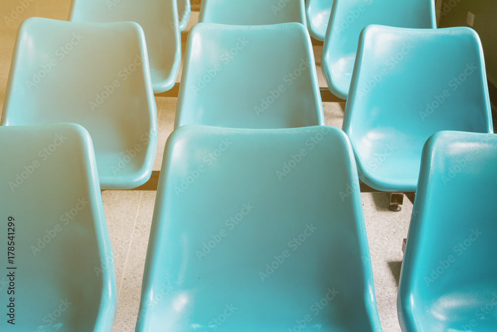 Fototapeta premium Rows of blue chairs of patients waiting for a doctor in the clinic at the hospital.