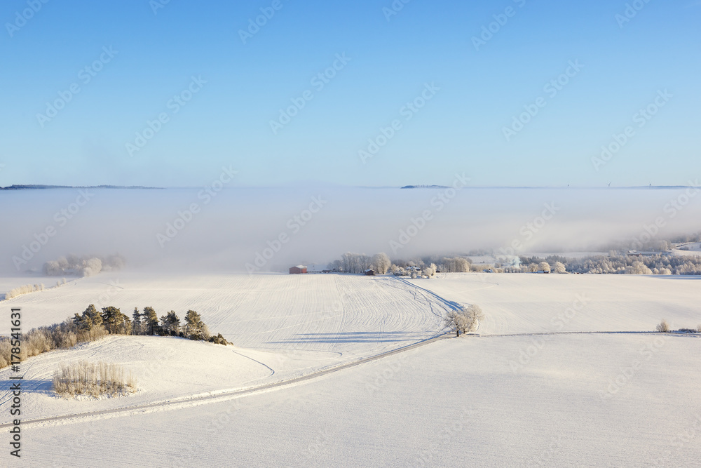Aerial view of a winter rural landscape with a road
