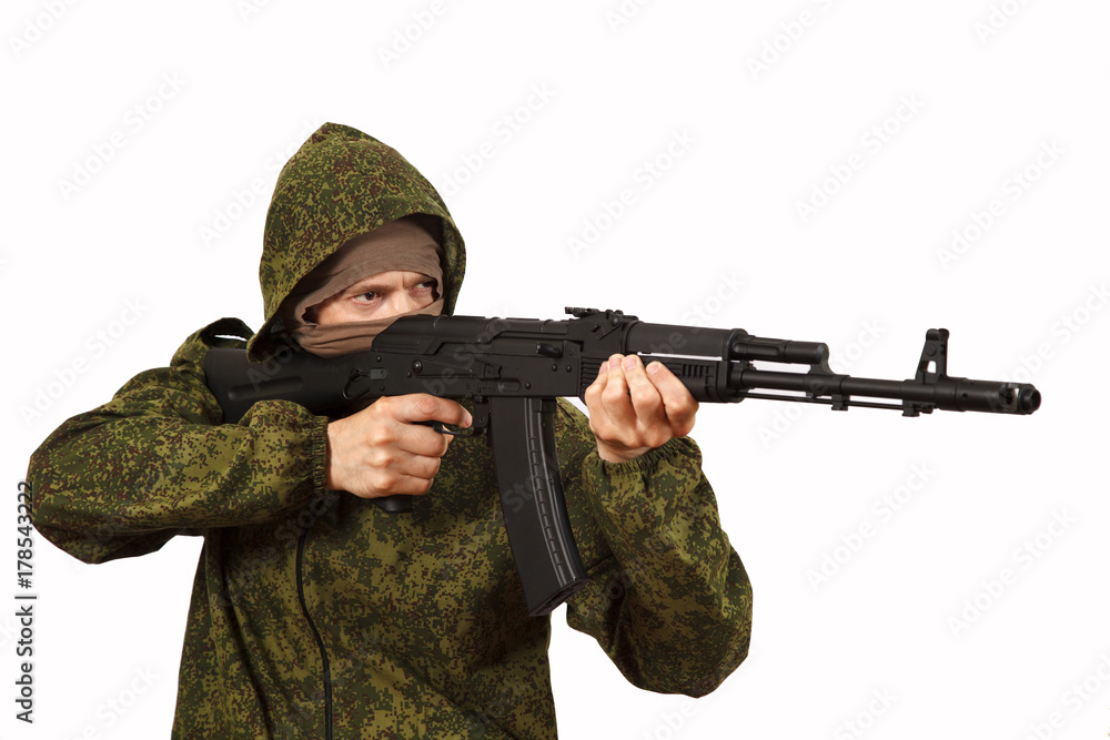 The man in a mask and a submachine gun in hands The man in a mask and a submachine gun in hands