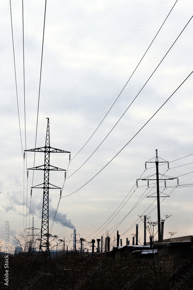 Urban environment. Power poles and factory fuming chimneys. Urban environment. Power poles and factory fuming chimneys.