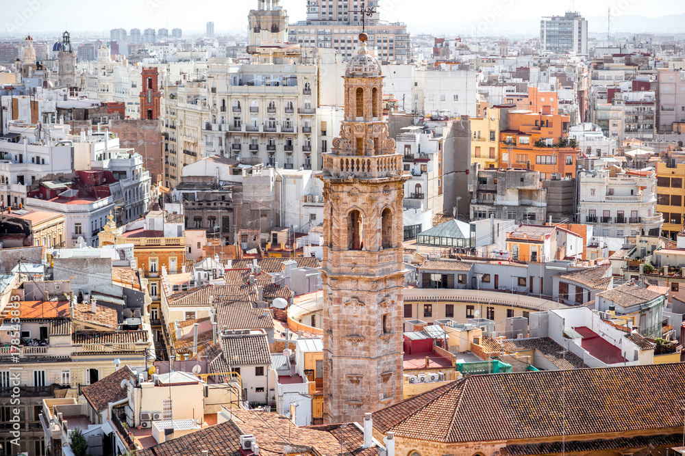 Top cityscape view on the old residential buildings with church tower in Valencia city during the sunny day in Spain