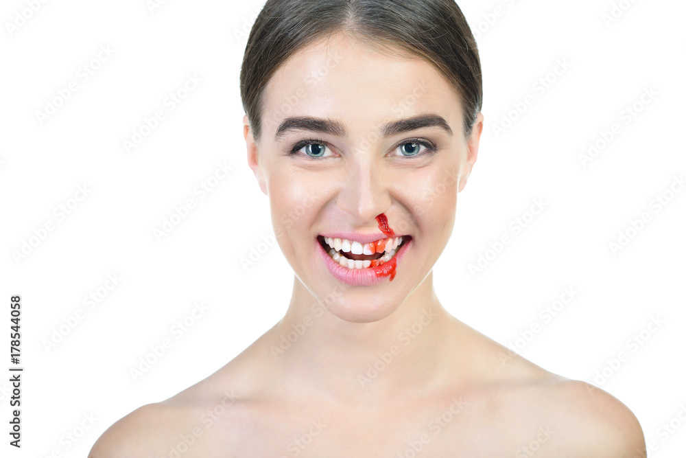 Laughing young beautiful woman with bleeding broken nose. Nosebleed. Violence in family, pain, weak blood vessels concept Laughing young beautiful woman with bleeding broken nose. Nosebleed. Violence in family, pain, weak blood vessels concept