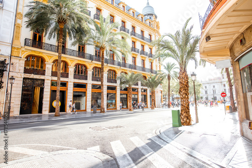 Street view with beautiful buildings and palm trees in Valencia city in Spain