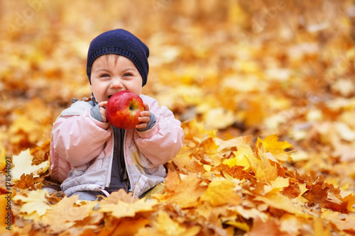 little laughing girl in the autumn park