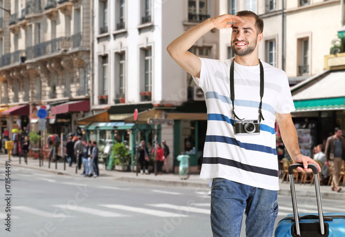 Young tourist with camera a...