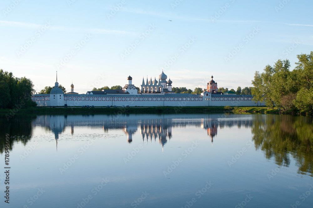 The reflection of the Tikhvin Assumption monastery in the waters of the Tabory pond, Tikhvin, Leningrad region, Russian Federation