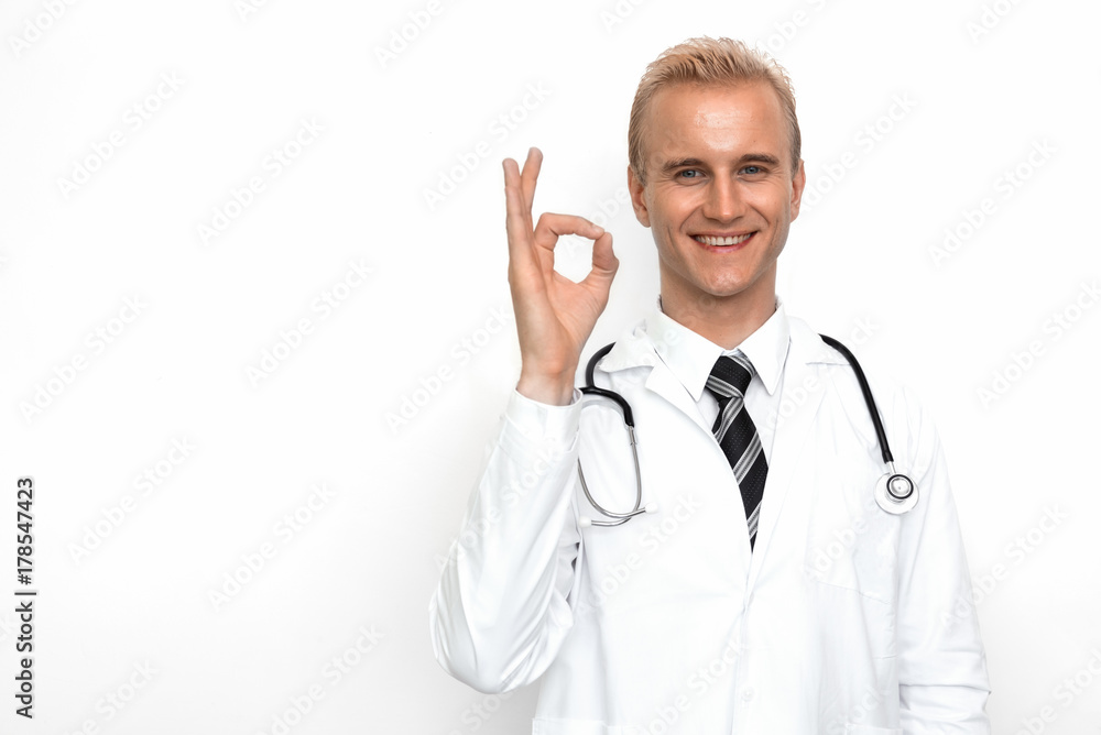 Doctor with stethoscope show off OK or all right sign by his hand on the white background. Medical and Healthcare concept. Hospital theme Doctor with stethoscope show off OK or all right sign by his hand on the white background. Medical and Healthcare concept. Hospital theme