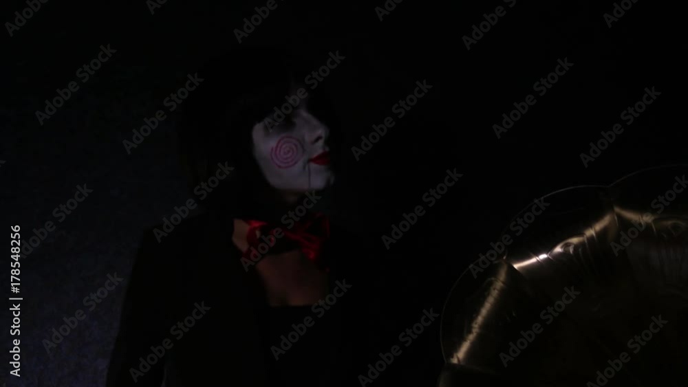 Mad girl sits and sings in studio on black background with gramophone. Lighting changes from light to shadow and back Mad girl sits and sings in studio on black background with gramophone. Lighting changes from light to shadow and back