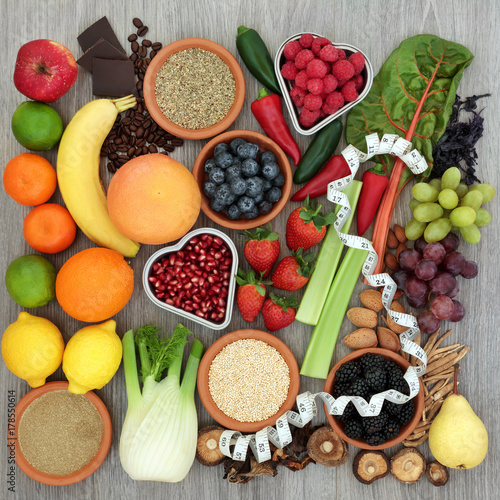 Fototapeta Naklejka Na Ścianę i Meble -  Diet health food concept with tape measure, vegetables, fruit, coffee, grains, nuts, chocolate and herbs with gymnema sylvestre and tribulus terrestris used as an appetite suppressant.  