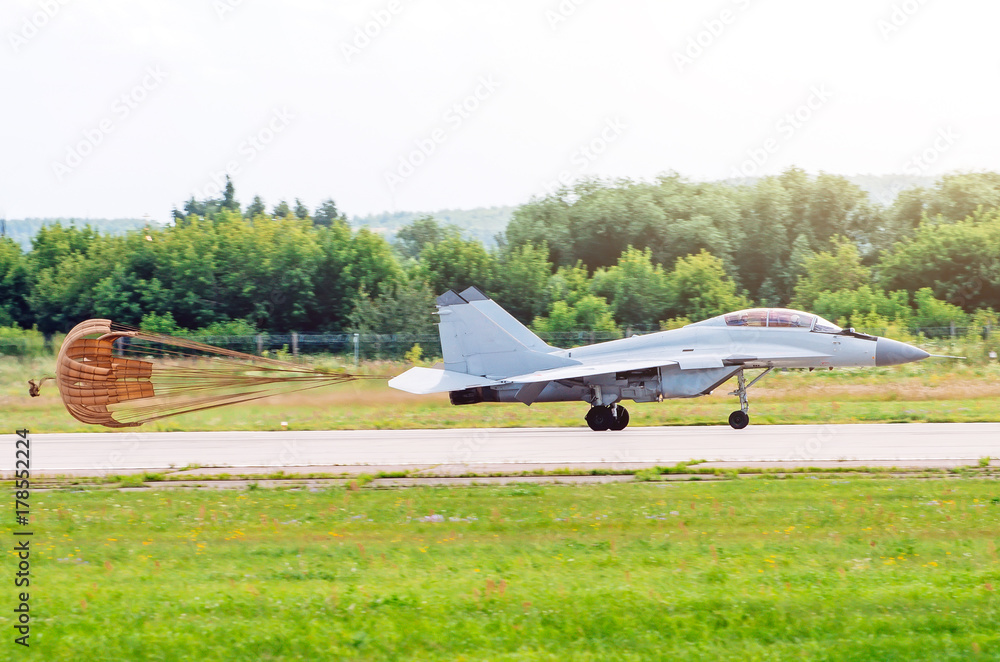Combat fighter after landing on the runway with the released parachute. Combat fighter after landing on the runway with the released parachute.