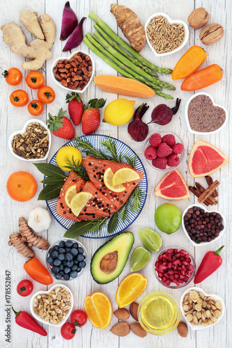 Fototapeta Naklejka Na Ścianę i Meble -  Health food for a healthy heart with salmon, vegetables, fruit, nuts, seeds, spices and herbs used in herbal medicine. Super food concept, high in omega 3, anthocyanins, antioxidants and vitamins.