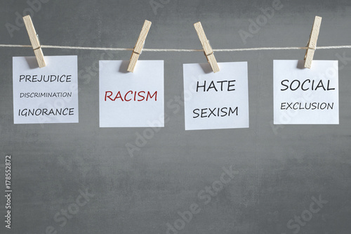 Hate, xenophobia, racism, sexism and other words on notes hanging on a clothesline. Social issues concept